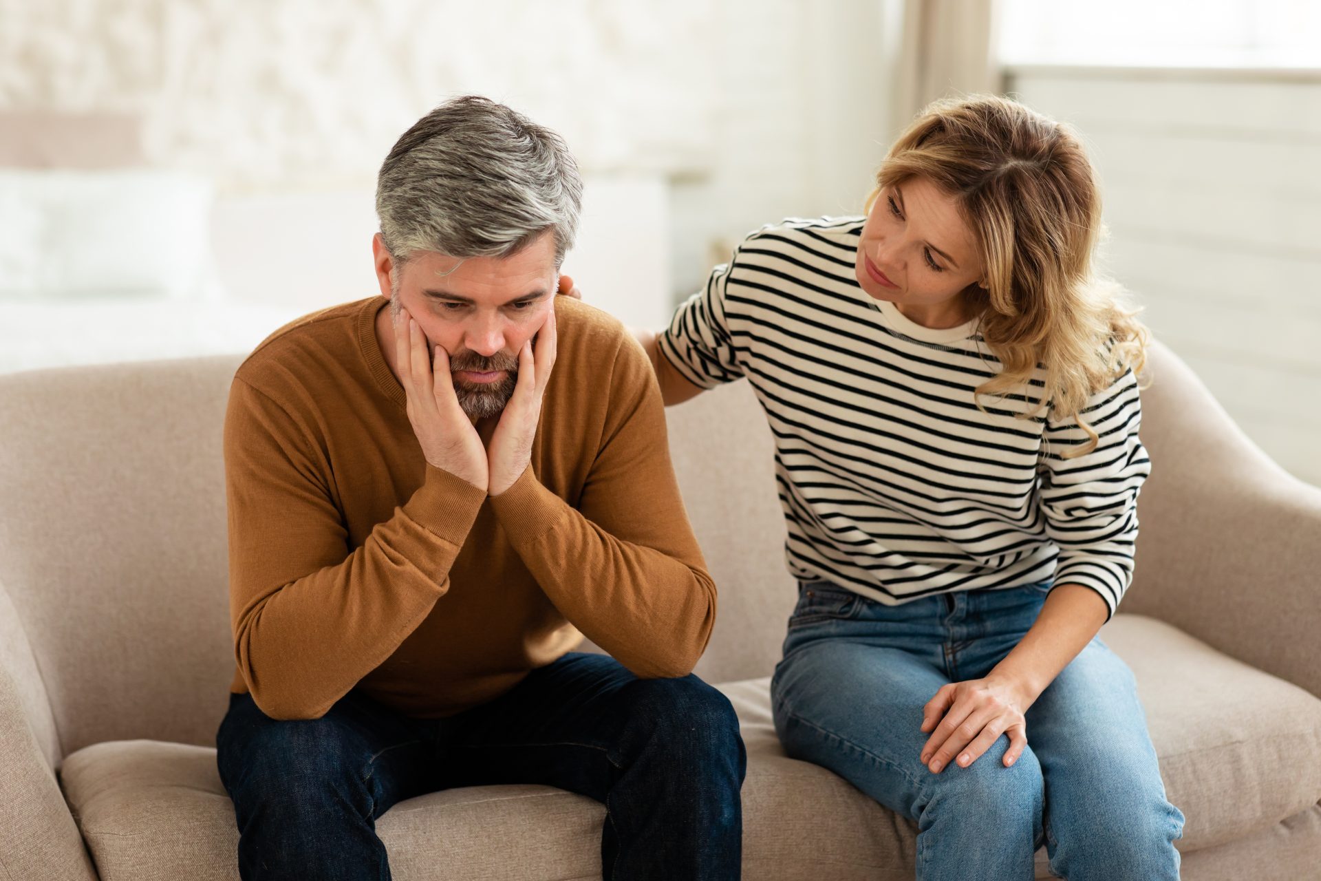 Middle Aged Wife Comforting And Supporting Depressed Husband At Home alt=""